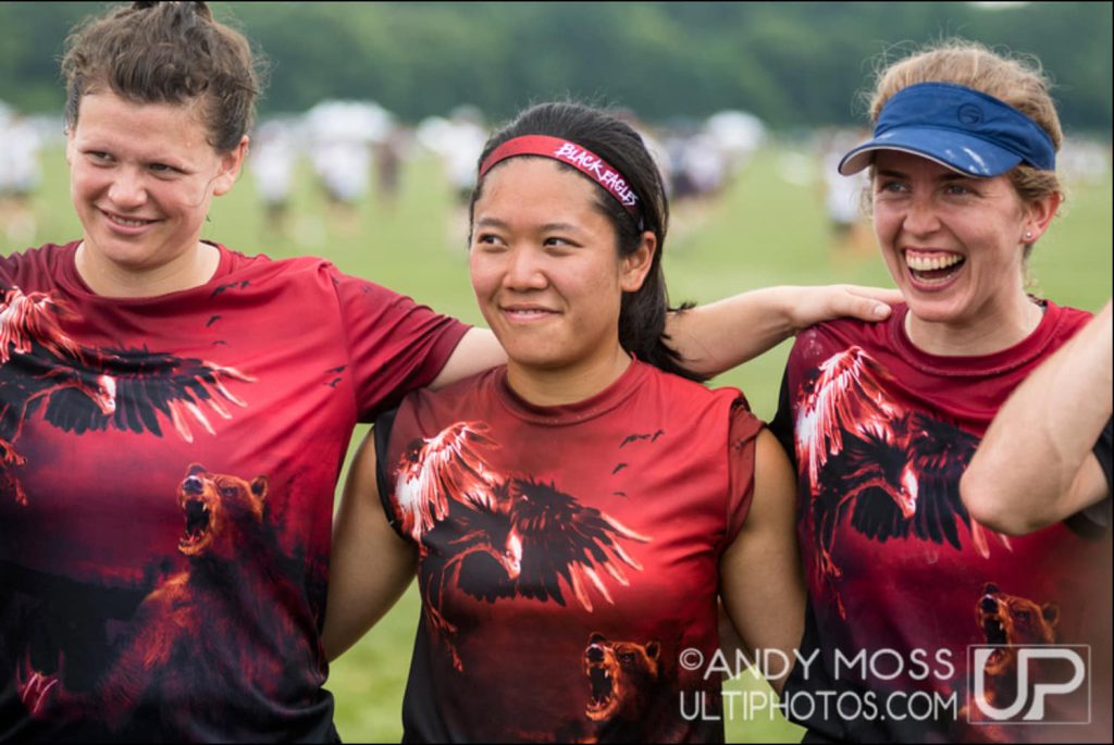 Natasha smiling next to her Black Eagles teammates at a tournament.